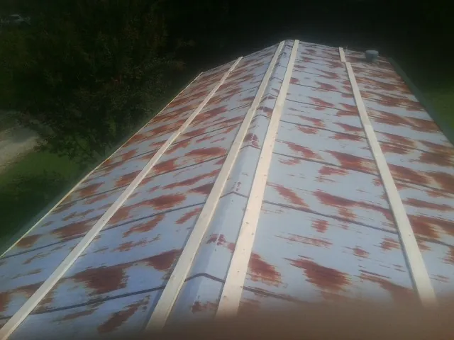 Rusted metal roof panels with new wood purlins before replacement — Storm Damage Roof Repair in Secaucus by Roofing Brothers