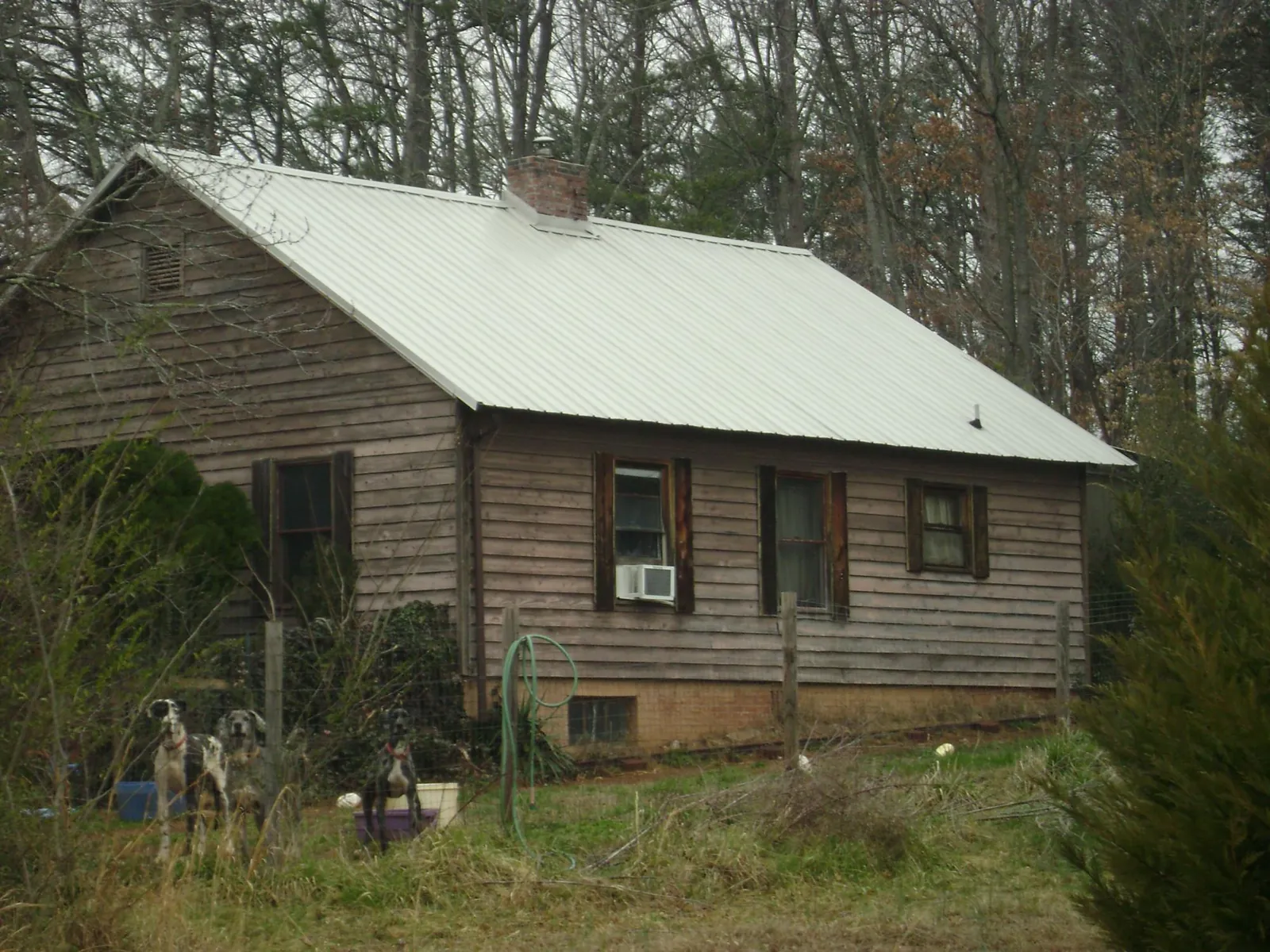 White metal roof on an old wood sided farmhouse, from a Asphalt Shingle Roof Repair job in Secaucus